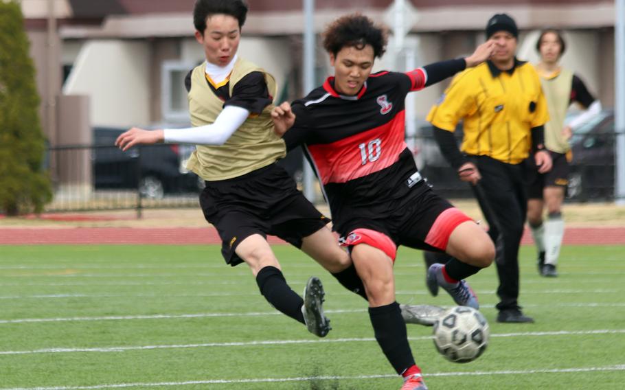 E.J. King’s Tyo Tominaga battles a Marist Brothers player for the ball during Saturday’s Perry Cup Silver Group playoff. The Bulldogs won 5-1 and captured fourth place in the tournament.