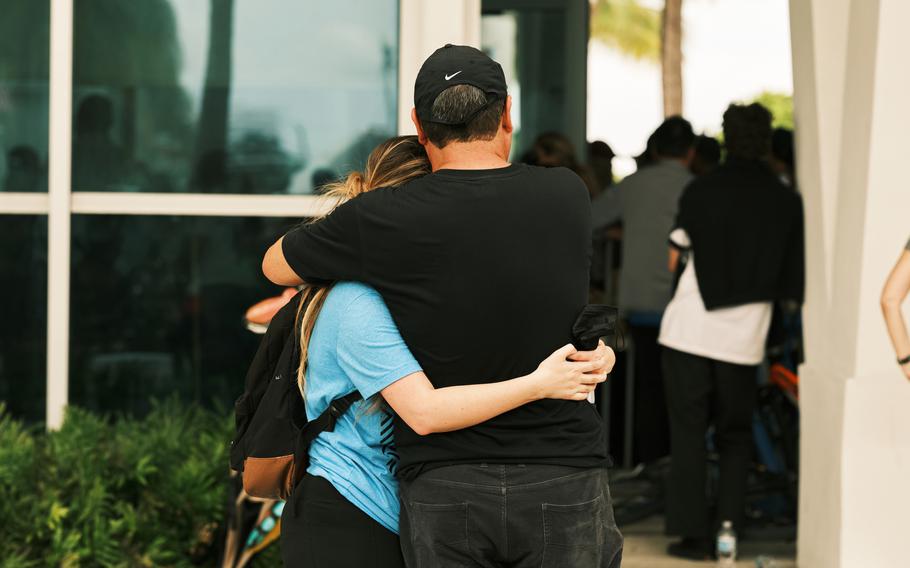 Friends and family wait for news about missing loved ones at the Surfside Community Center. 