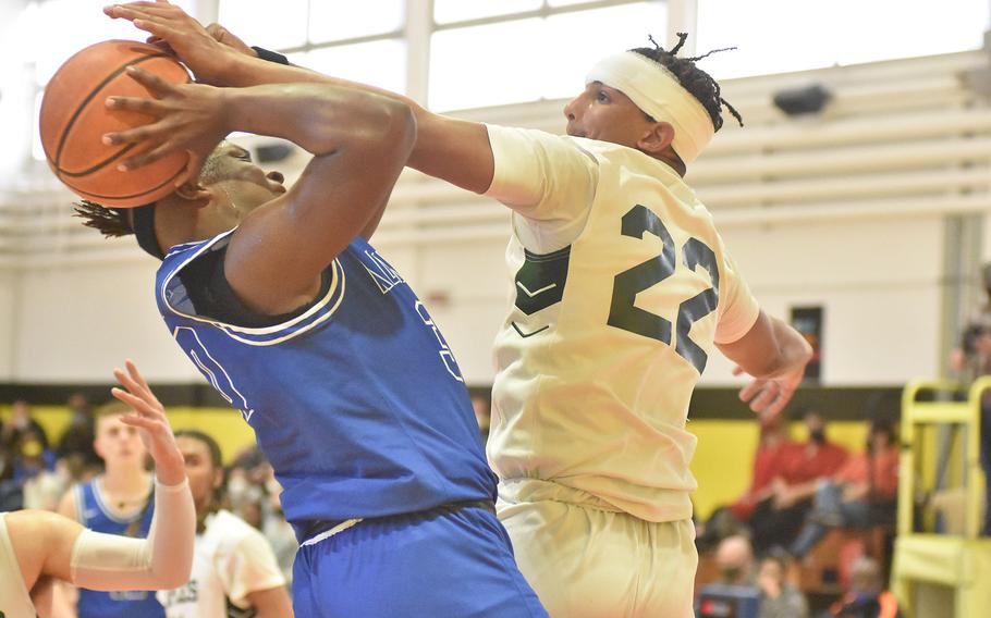Naples' Keshawn Holland blocks the shot of Rota's Kennith Bryant on Saturday, March 5, 2022, in the title game of the DODEA-Europe Division II boys basketball championships.