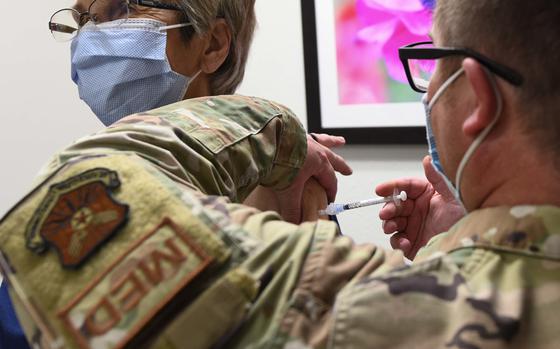 Tech. Sgt. Jason Hanafin, 90th Medical Group NCOIC of allergy and immunizations, administers a COVID-19 vaccine at the immunizations clinic on F.E. Warren Air Force Base, Wyoming, Dec. 6, 2021. 