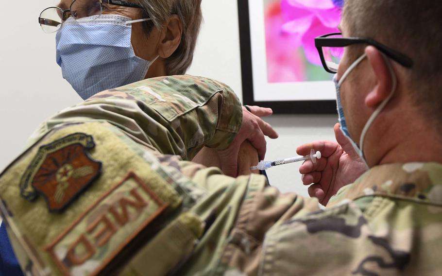 Tech. Sgt. Jason Hanafin, 90th Medical Group NCOIC of allergy and immunizations, administers a COVID-19 vaccine at the immunizations clinic on F.E. Warren Air Force Base, Wyo., Dec. 6, 2021. 