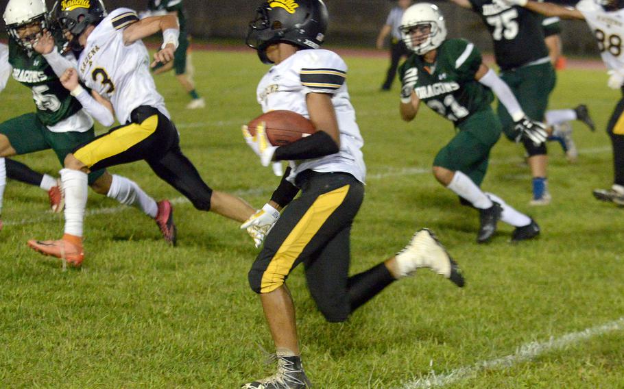 Kadena running back B.J. Taylor follows blocks around left end against Kubasaki.