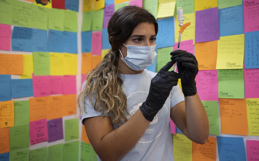 A healthcare worker prepares a dose of the Novavax Covid-19 vaccine at a pharmacy in Schwenksville, Pa., on Aug. 1, 2022. 