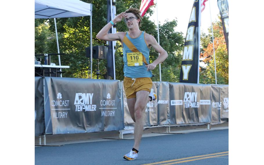 George Washington University Law School student Luke Peterson crosses the finish line as the winner of the Army 10-Miler Sunday at the Pentagon. Peterson, who led all the way, was timed in 49:58.24, about 13 seconds ahead of runner-up Makorobondo Salukombo.