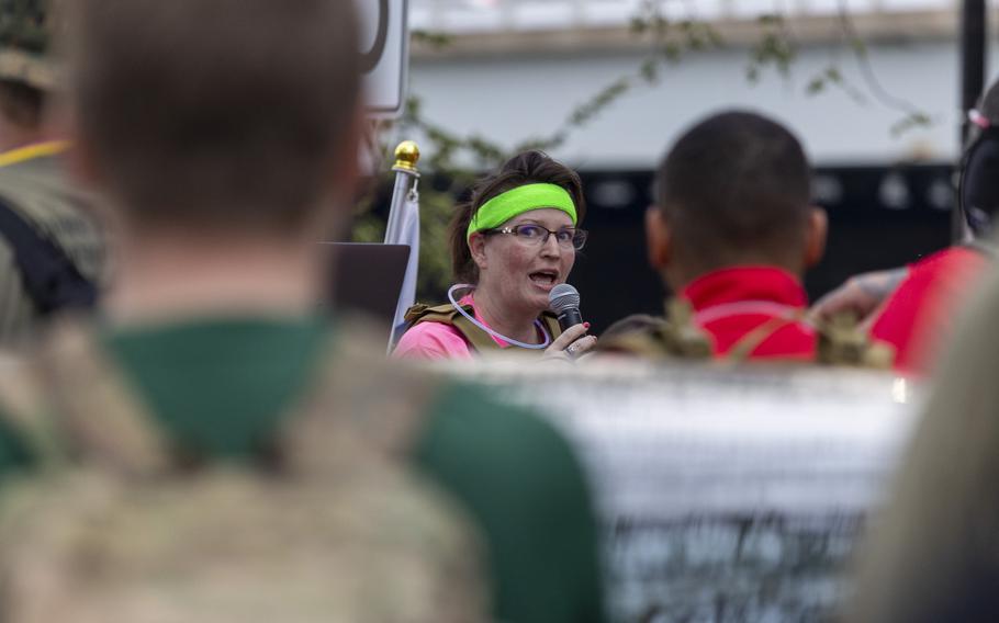 A woman speaks with a microphone