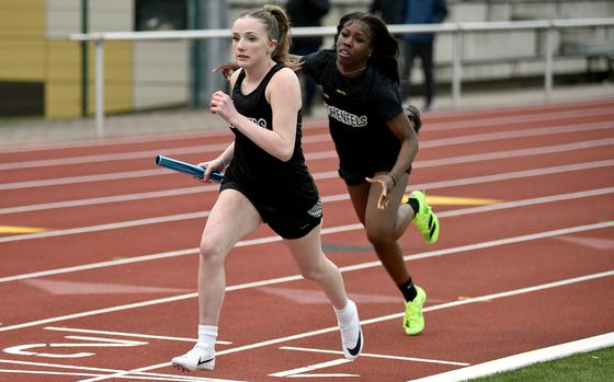 Hohenfels' Emma Taylor runs forward after receiveing the baton from teammate Keaira Satchel during the girls sprint medley relay at a track and field meet on March 14, 2025, at Kaiserslautern High School in Kaiserslautern, Germany.