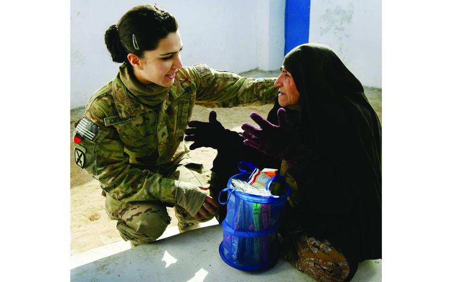 Sgt. Lidya Admounabdfany listens to an Afghan woman at the Women’s Center at Forward Operating Base Pasab, Afghanistan. Admounabdfany was 10 years old when the U.S. invaded Iraq. Now an American citizen, she serves in the 52nd Translator/Interpreter Company, 5th Battalion, 353rd Infantry Regiment.