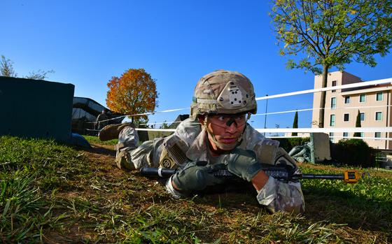 A U.S. Army paratrooper from the 173rd Airborne Brigade low crawls during the week-long Expert Infantryman Badge, Expert Soldier Badge and Expert Field Medical Badge training at Caserma Del Din, Vicenza, Italy, Oct. 28, 2022.