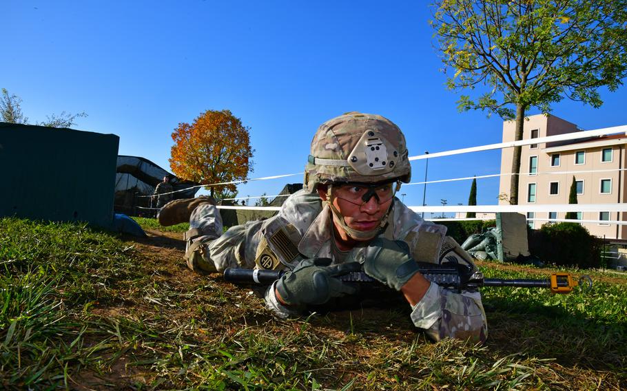 A U.S. Army paratrooper from the 173rd Airborne Brigade low crawls during the weeklong Expert Infantryman Badge, Expert Soldier Badge and Expert Field Medical Badge training at Caserma Del Din, Vicenza, Italy, Oct. 28, 2022.