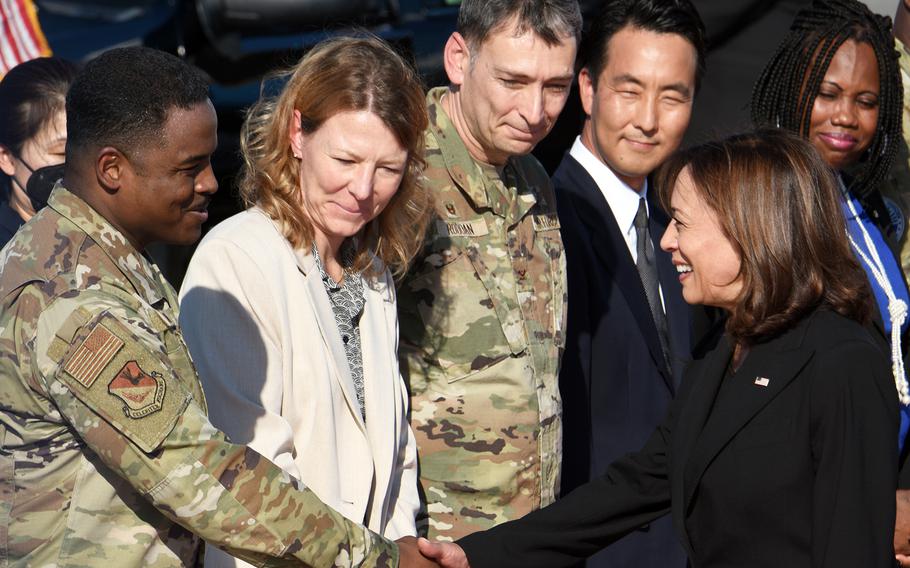 Vice President Kamala Harris greets Chief Master Sgt. Jerry Dunn of the 374th Airlift Wing upon her arrival at Yokota Air Base, Japan, Monday, Sept. 26, 2022.