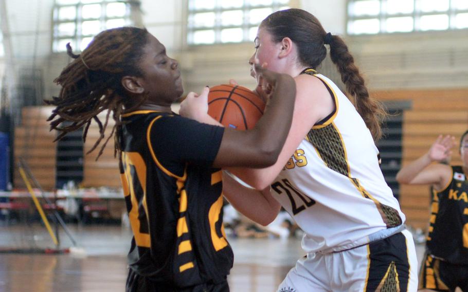 Gimme that ball! Kadena's Jayla Johnson and American School In Japan's Ava Piscopo tie up the ball during Saturday's Okinawa-American Friendship Tournament pool-play game. The Mustangs edged the Panthers 42-40 in extra time.