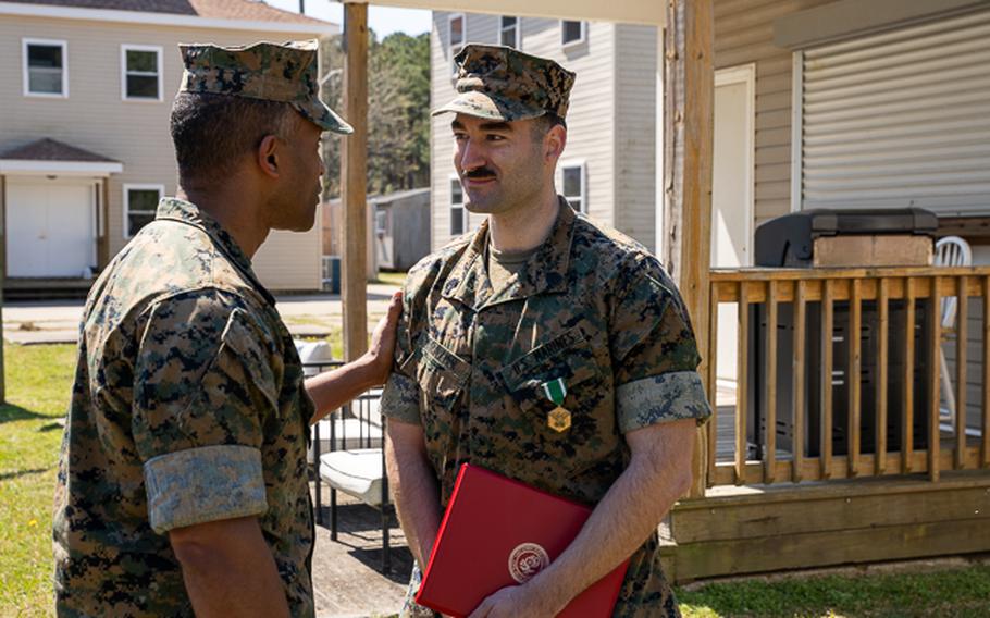 U.S. Marine Corps Gunnery Sgt. Benjamin Frazier receives congratulations after being awarded the Navy and Marine Corps Commendation Medal at Naval Air Station Dam Neck, Va., Thursday, March 21, 2024. 