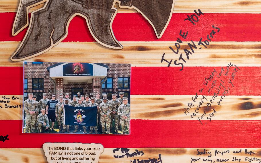 A plaque with photos and signatures with well wishes.