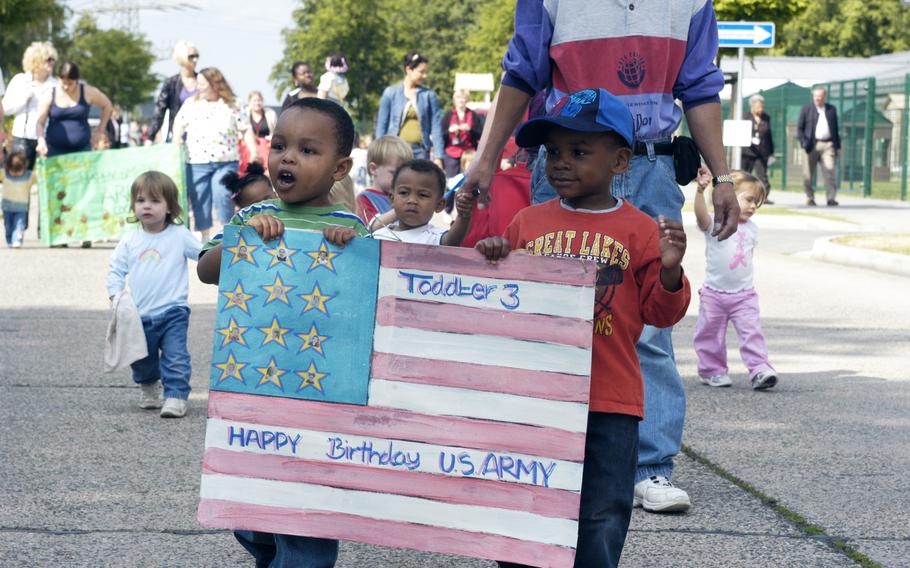 Children hold an American flag poster together