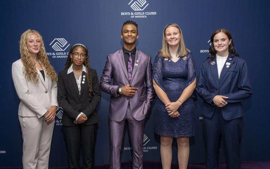 Five teenagers pose for a photo.
