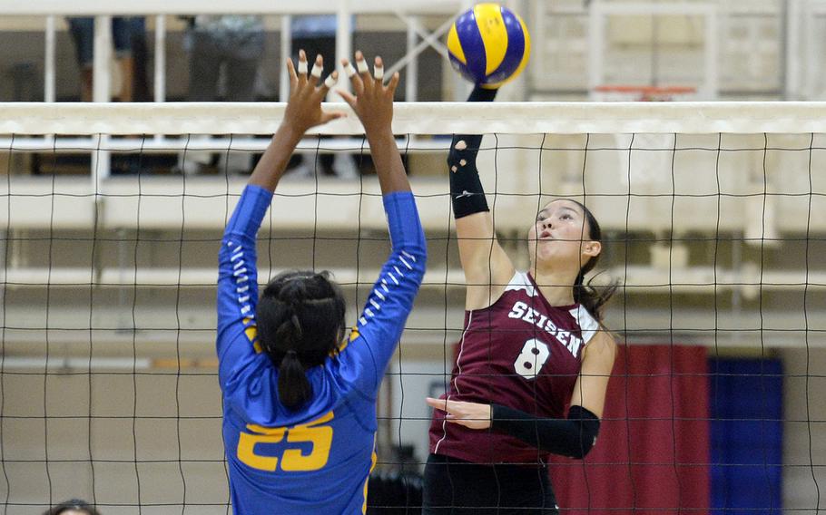 Seisen's Lisa Purcell spikes against Yokota's Trinity Stegall during Tuesday's Kanto Plain volleyball match. The host Phoenix won in three sets.