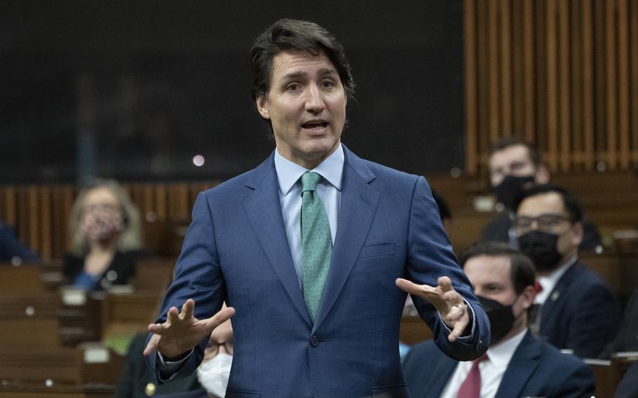 Prime Minister Justin Trudeau speaks about the implementation of the Emergencies Act, Thursday, Feb. 17, 2022 in Ottawa.  Police poured into downtown Ottawa on Thursday in what truckers feared was a prelude to a crackdown on their nearly three-week, street-clogging protest against Canada’s COVID-19 restrictions. 