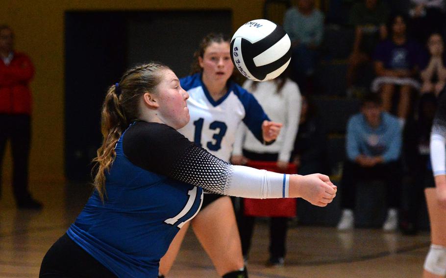 Brussels’ Nora Gibbons bumps the ball as teammate Tessa Wedekind watches in the Brigands’ 25-21, 17-25, 25-20, 25, 20,  loss to Ansbach in the Division III final at the DODEA-Europe volleyball championships at Ramstein, Germany, Oct. 28, 2023.