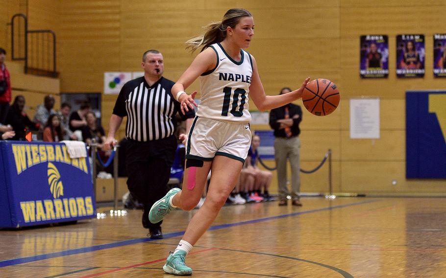 Naples sophomore Gracie Grannis dribbles during a Division II semifinal against Rota at the DODEA European Basketball Championships on Feb. 16, 2024, at Wiesbaden High School in Wiesbaden, Germany.