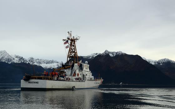 Mustang underway with snow-capped mountains in the background.