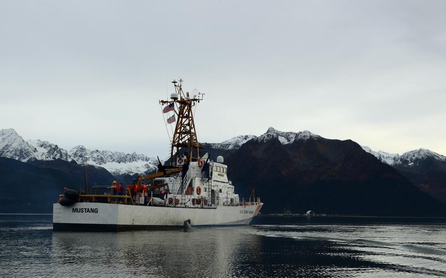 Mustang underway with snow-capped mountains in the background.