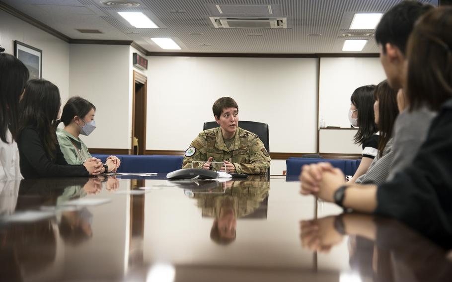 Air Force Col. Julie Gaulin, vice commander of the 374th Airlift Wing, meets with Japanese university students during a tour of Yokota Air Base, Japan, Thursday, April 20, 2023.