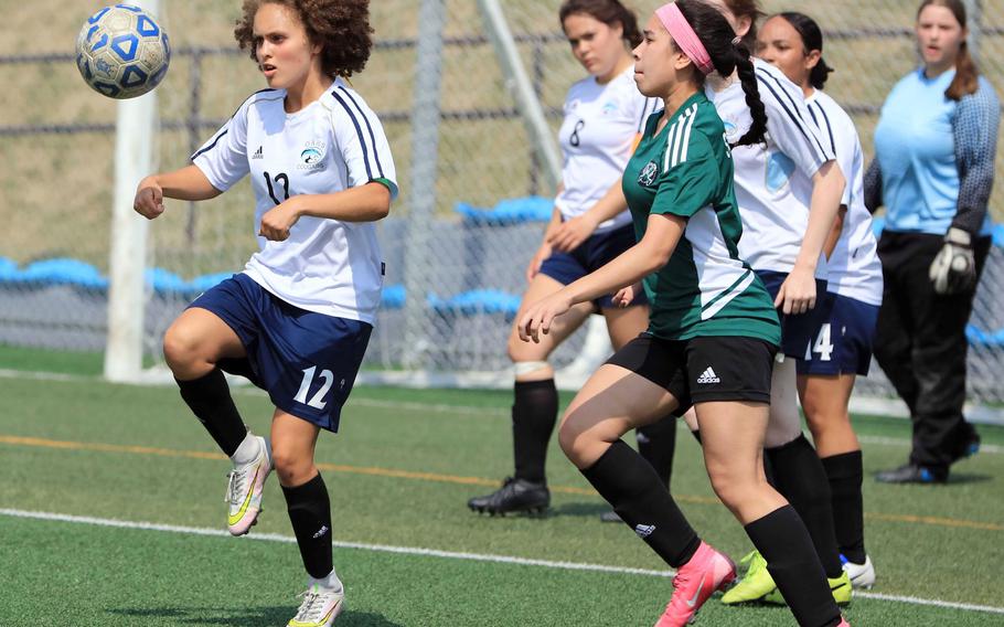 Osan's Riley Hunt tries to settle the ball in front of Daegu's Jaela Sahagun during Tuesday's DODEA-Korea soccer match. The Warriors won 4-3.