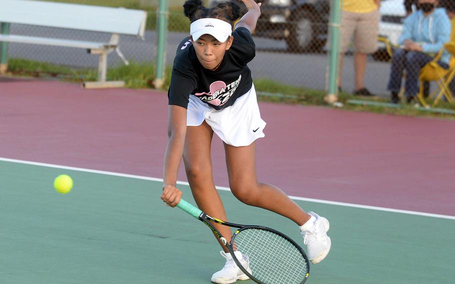 Kadena's Christine Ryan lunges to return a backhand shot against teammate Mayann Rivera.