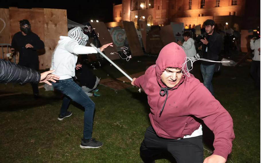 Pro-Palestinian protesters clash with a pro-Israeli supporters at an encampment at UCLA on May 1, 2024.