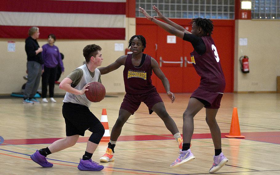 Baumholder's Greg Makubaya and Davion Haywood go to trap Richard Rivera Suarez during a Nov. 28, 2023, practice at the Hall of Champions in Baumholder, Germany.