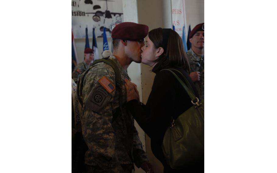 Sgt. Clayton Gauard, an infantryman with 1st Battalion, 325th Airborne Infantry Regiment, 2nd Brigade Combat Team, 82nd Airborne Division shares a kiss with his wife, Jamie Gauard, after returning from a 16-month deployment in support of Operation Iraqi Freedom in November 2007. 