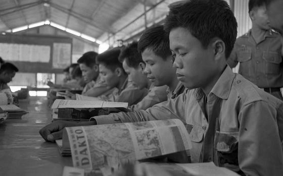 Hed: Bien Hoa Prisoner of War Camp, 1968: 

Bien Hoa, Vietnam, Aprilm 1968: Viet Cong, in their spare time, read "Free World" magazines. One can be seen reading an article on Dak To.

The Bien Hoa prisoner of war camp, run by the Army of the Republic of Vietnam, with assistance from U.S. advisors -   is a compex of 55 buildings - barracks, kitchens, mess halls, libraries and a dispensary with a doctor.

"The Bien Hoa POW camp is peaceful. Almost serene. The prisoners look happy. They look well fed. They smile and wave. Occasionally, a visitor sees a look of hate," the original article read. 

Read the 1968 article on the POW camp here.
https://www.stripes.com/history/1968-05-26/from-the-s&s-archives:the-nameless-girls-of-bien-hoa-1913325.html

Looking for Stars and Stripes’ coverage of the Vietnam War? Subscribe to Stars and Stripes’ historic newspaper archive! We have digitized our 1948-1999 European and Pacific editions, as well as several of our WWII editions and made them available online through https://starsandstripes.newspaperarchive.com/

META TAGS: South Vietnam; war; Vietnam war; prisoners of war; POW; POW camp; North Vietnamese Army; NVA; Viet Cong; VC; prison; reading

