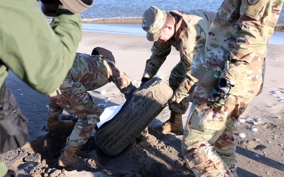 U.S. soldiers work together to clean up Nobiru Beach in Miyagi prefecture, Japan, on Dec. 13.