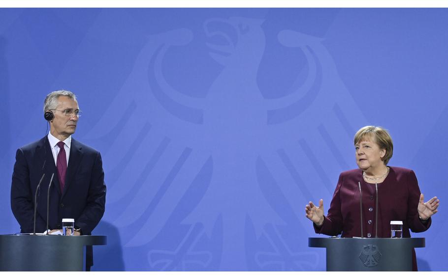 German Chancellor Angela Merkel, right, and NATO Secretary General Jens Stoltenberg attend a briefing Berlin, Germany, on Friday, Nov. 19, 2021.