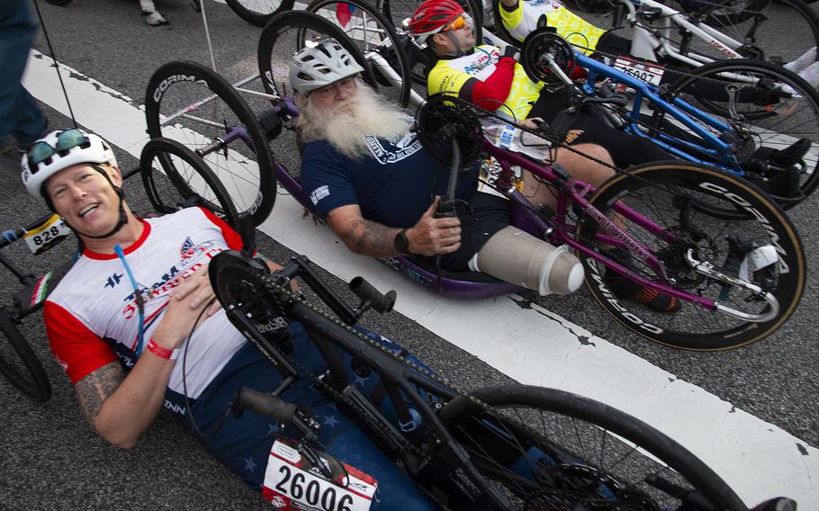 Jay McManus, foreground, and other wheelchair and hand-crank competitors await the start of the 48th Marine Corps Marathon on Sunday, Oct. 29, 2023, in Arlington, Va.