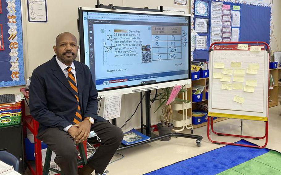 Second grade teacher Nathan Rogers poses in his classroom at Shirley Lanham Elementary at Naval Air Facility Atsugi, Japan, Oct. 19, 2022.