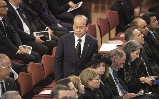 China’s ambassador to Australia Xiao Qian walks past seats in Australia’s Great Hall of Parliament.