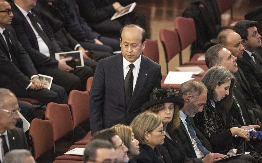 China’s ambassador to Australia Xiao Qian walks past seats in Australia’s Great Hall of Parliament.