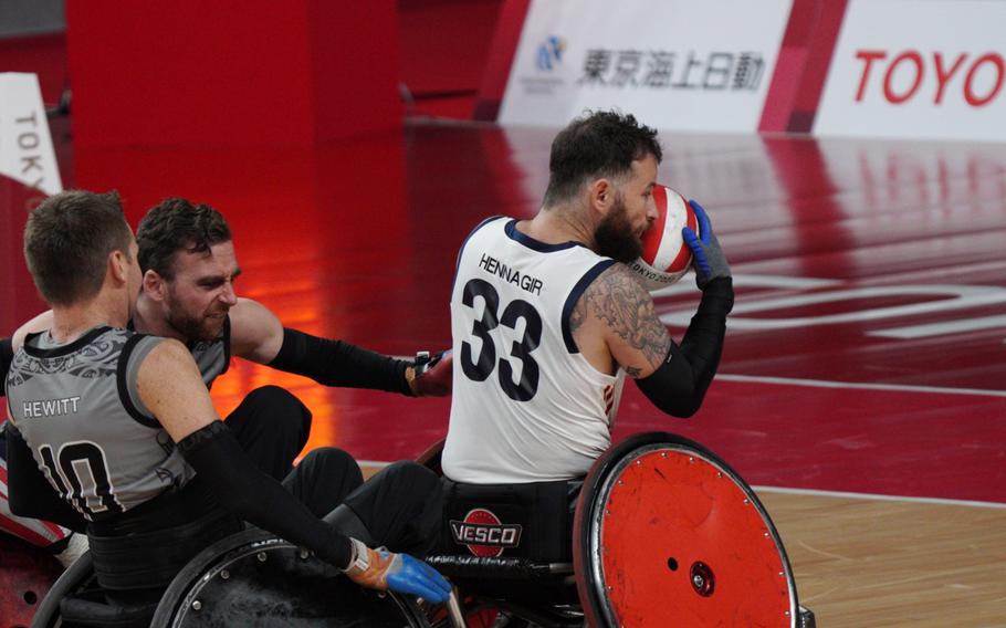 Former Marine Raymond Hennagir grabs the ball in Team USA’s wheelchair rugby win over New Zealand during the Tokyo Paralympics, Wednesday, Aug. 25, 2021.