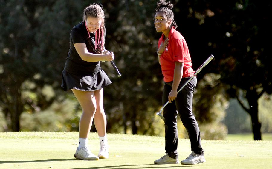 Stuttgart’s Tayor Kreimeier, left, and Kaiserslautern’s Asia Andrews share a laugh on the No. 18 green Thursday during the DODEA European golf championships at the Rheinblick Golf Course in Wiesbaden, Germany.