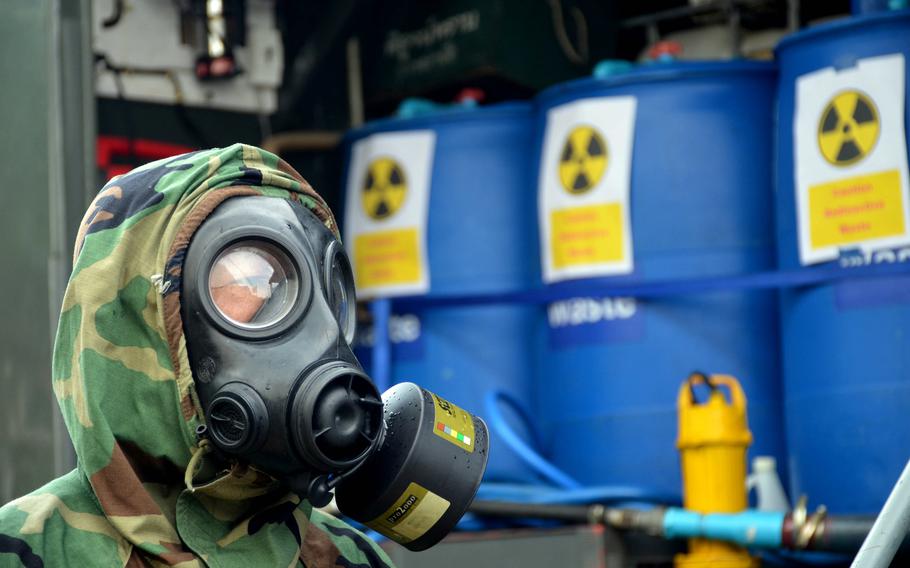 A Thai airman stands near radioactive waste during a Cobra Gold evacuation and decontamination drill in Rayong, Thailand, on March 3, 2024. 
