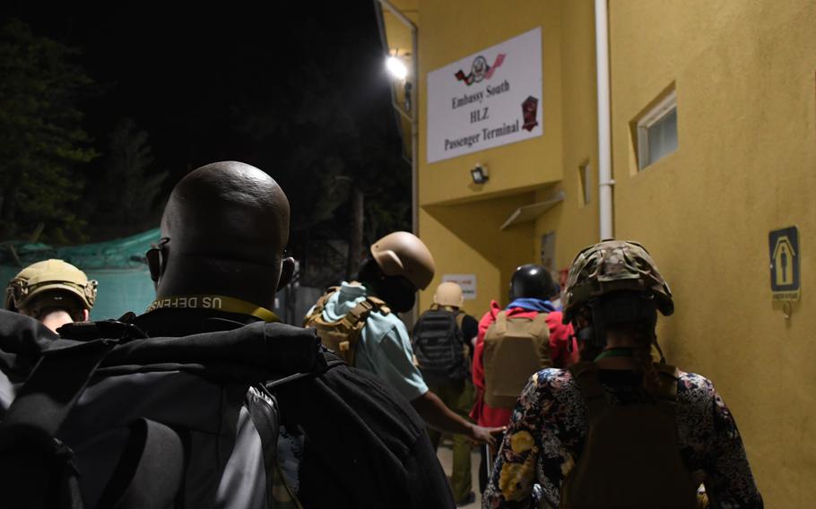 Staff members at the U.S. Embassy in Kabul, Afghanistan, evacuate shortly after midnight, Aug. 15, 2021. Some Afghans with visas to enter the U.S. had their passports lost or destroyed at the embassy prior to the Taliban takeover, leaving them without the paperwork they need to leave the country.