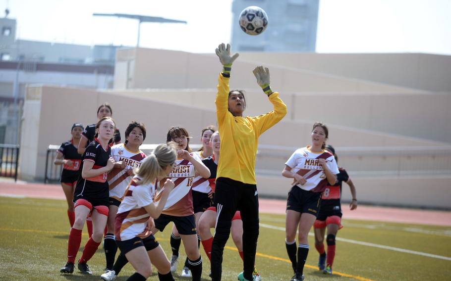 Marist Brothers keeper Sneha Shah goes up to swat away an E.J. King corner kick.