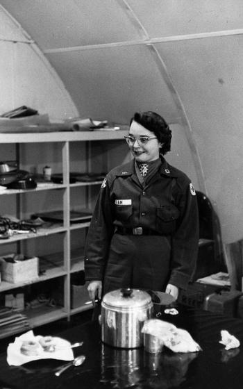 A woman stands in uniform