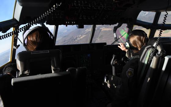 Capts. Tiffany Haines, left, and Megan Kraynak take advantage of clear skies over Ramstein Air Base, Germany, on March 18, 2022, to conduct training in a C-130J. The pilots are members of the 37th Airlift Squadron, which transports personnel and materiel throughout Europe and Africa. They led a three-aircraft training formation comprised of all women.  