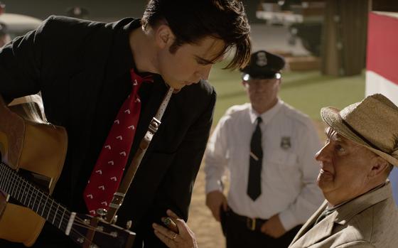 This image released by Warner Bros. Pictures shows Austin Butler and Tom Hanks in a scene from "Elvis." 