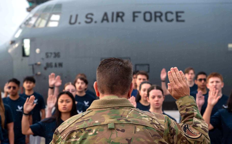 Brig. Gen. Christopher Amrhein, commander of the Air Force Recruiting Service, swears in new recruits at Ramstein Air Base, Germany.