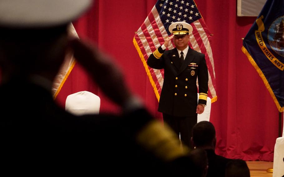 Rear Adm. Leonard Dollaga, the outgoing Submarine Group 7 commander, salutes during a change-of-command ceremony at Yokosuka Naval Base, Japan.