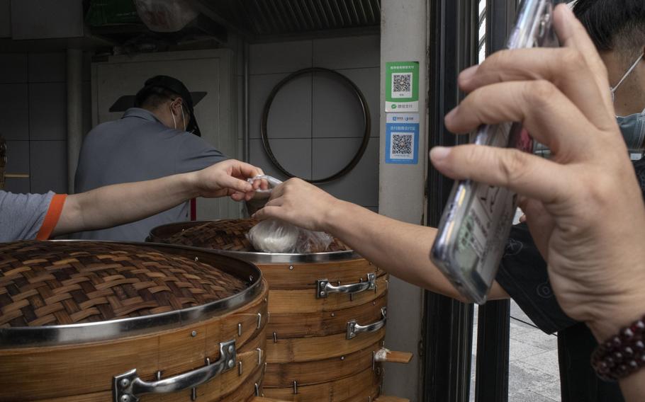 QR codes for Ant Group’s Alipay and Tencent’s WeChat Pay at a snack shop in Beijing. 