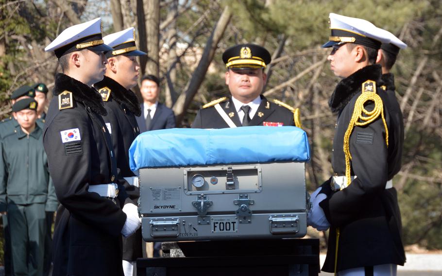 South Korean troops carry the remains of a U.S. service member who died in the Korean War during a repatriation ceremony at Seoul National Cemetery, Wednesday, Feb. 22, 2023.